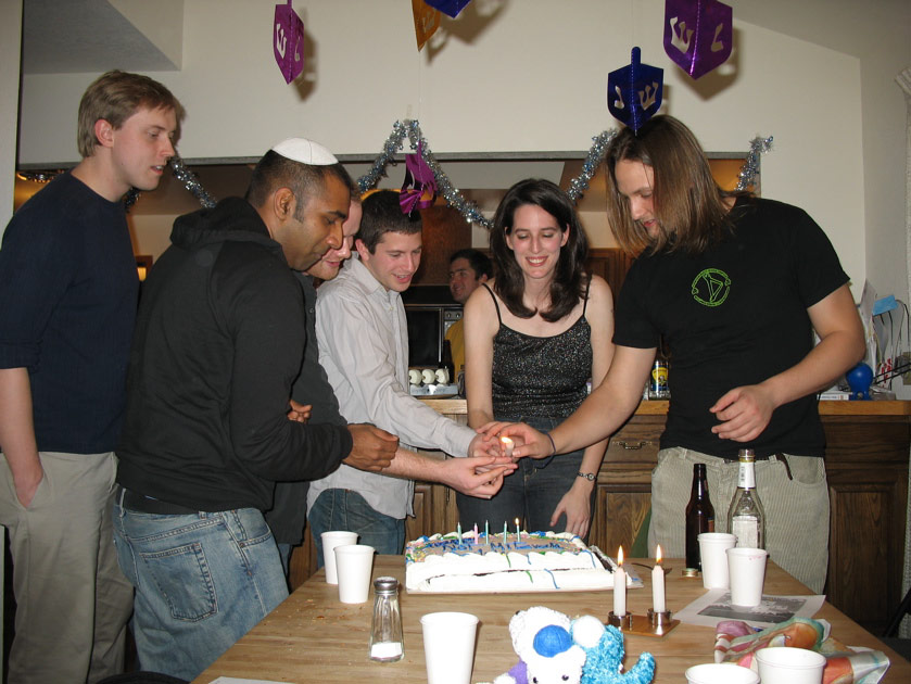 Julie lights a candle for the hosts of the party