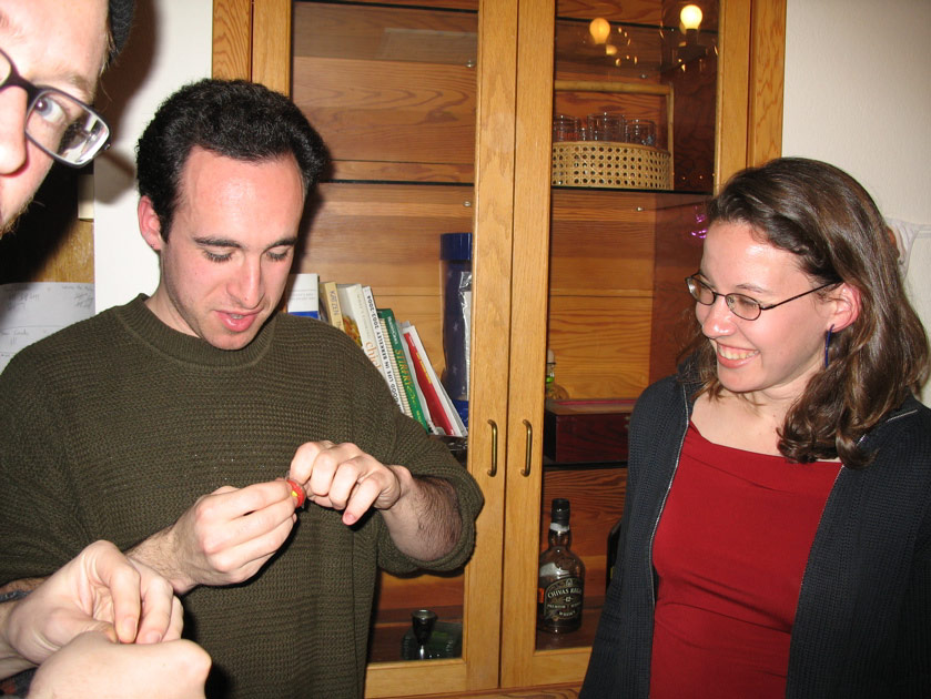 Mike, Noah, and Kristen play with their cracker toys